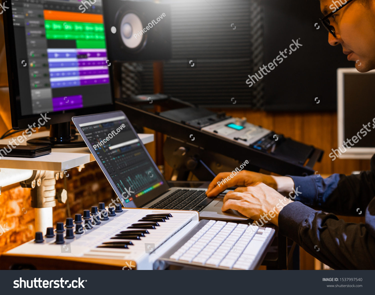 stock-photo-male-producer-musician-composer-making-a-song-in-home